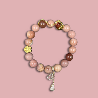 Baby Pink Agate Bracelet & 14k golden plated charms of flower, moon, and calabash - top view